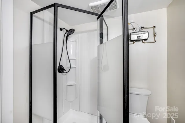 a bedroom with a bed and a potted plant