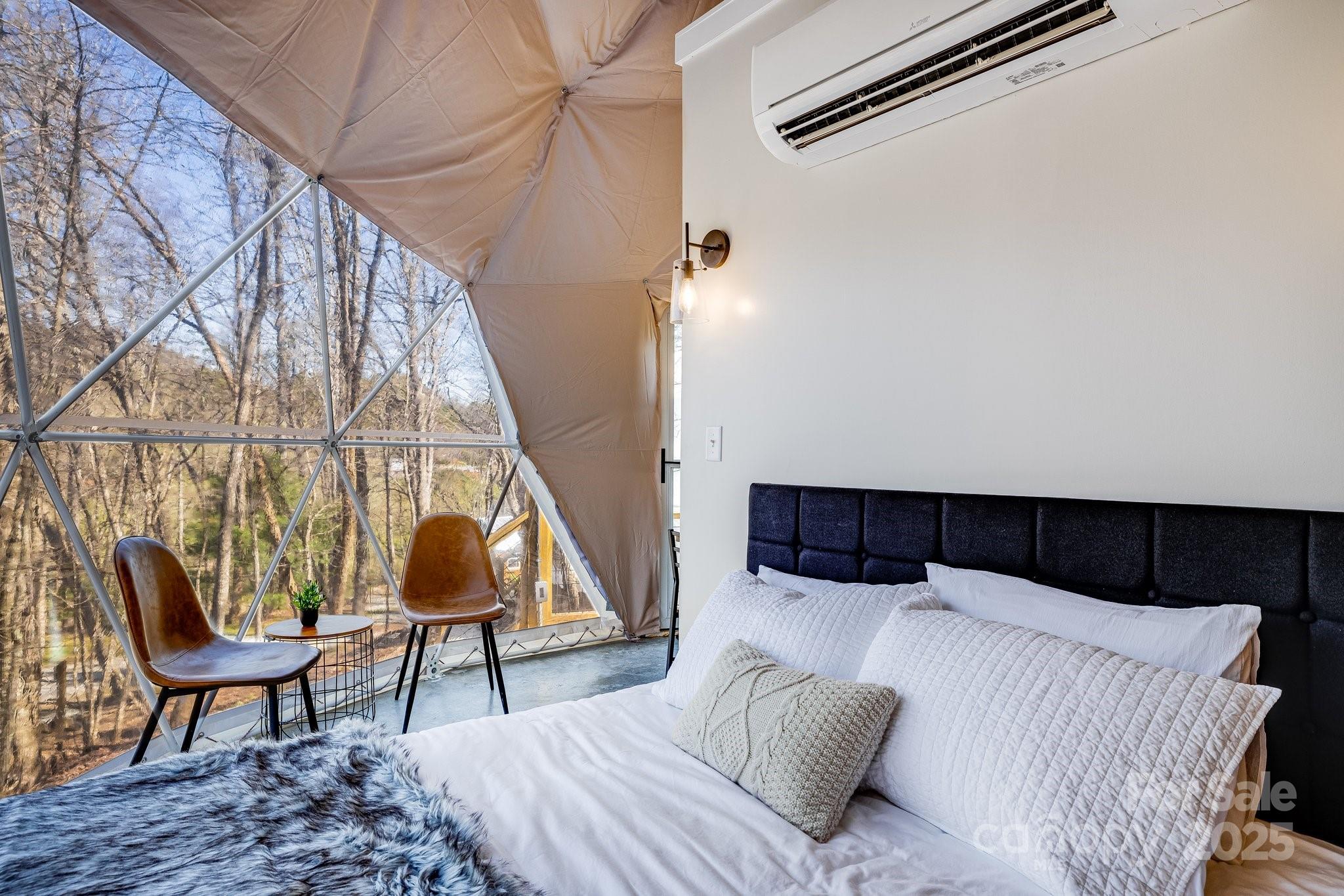 186 L Meece Road Rosman, NC 28772 - Photo 22 of 45 a bedroom with a bed and a potted plant