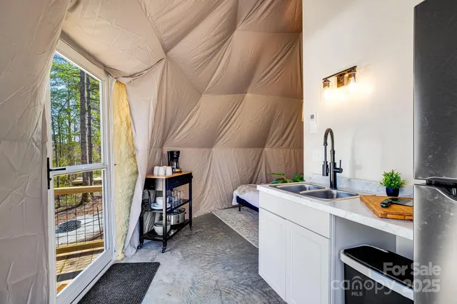 a living room with furniture a rug and white walls