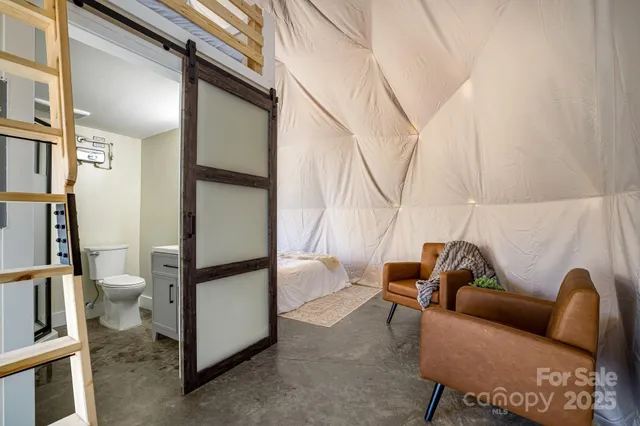 a living room with furniture and stairs