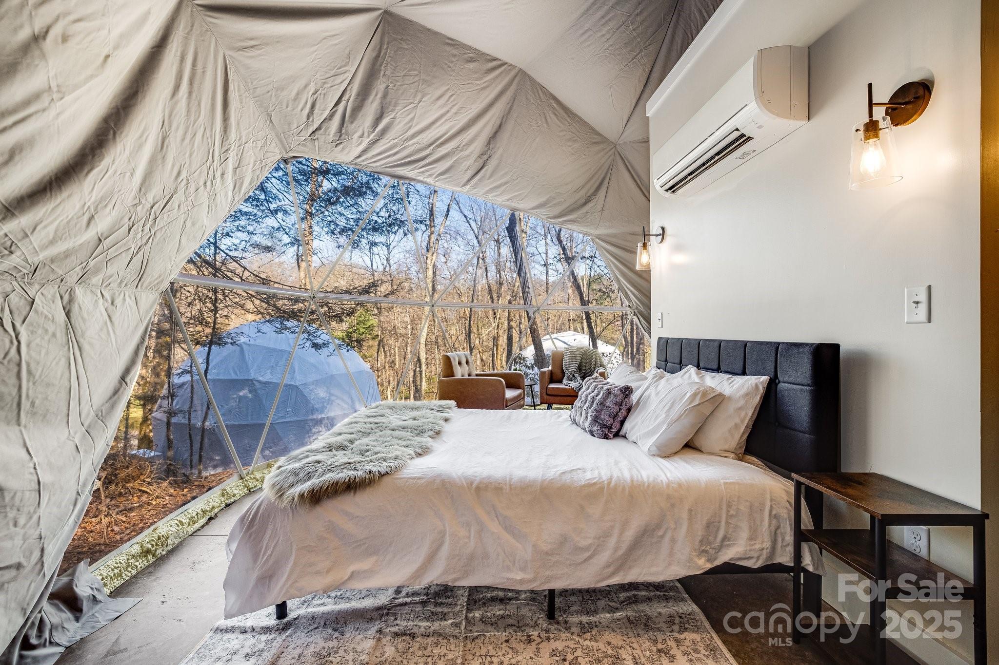 186 L Meece Road Rosman, NC 28772 - Photo 3 of 45 a bedroom with a bed and a mirror