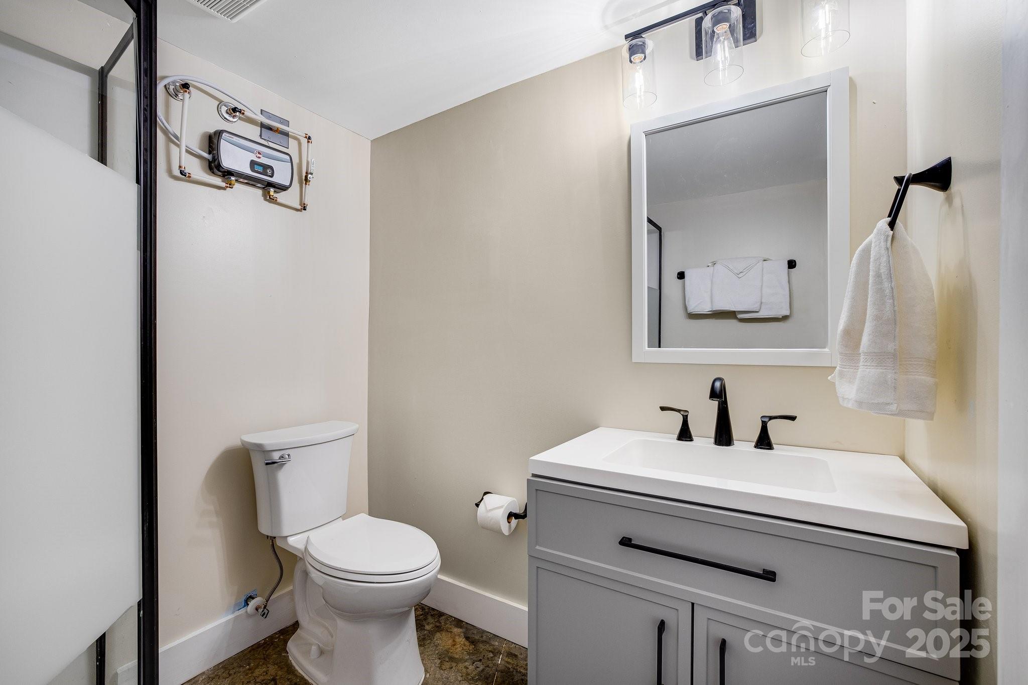 186 L Meece Road Rosman, NC 28772 - Photo 31 of 45 a bathroom with a toilet sink and mirror