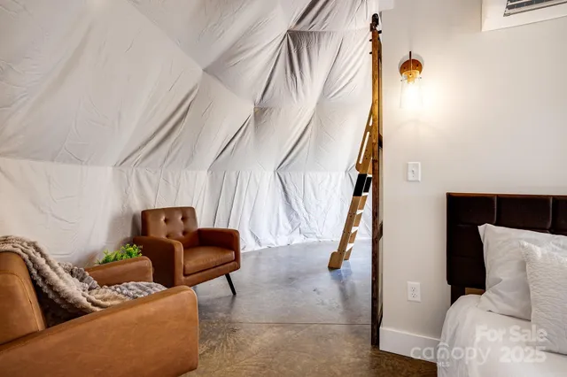 a bedroom with a bed and a potted plant