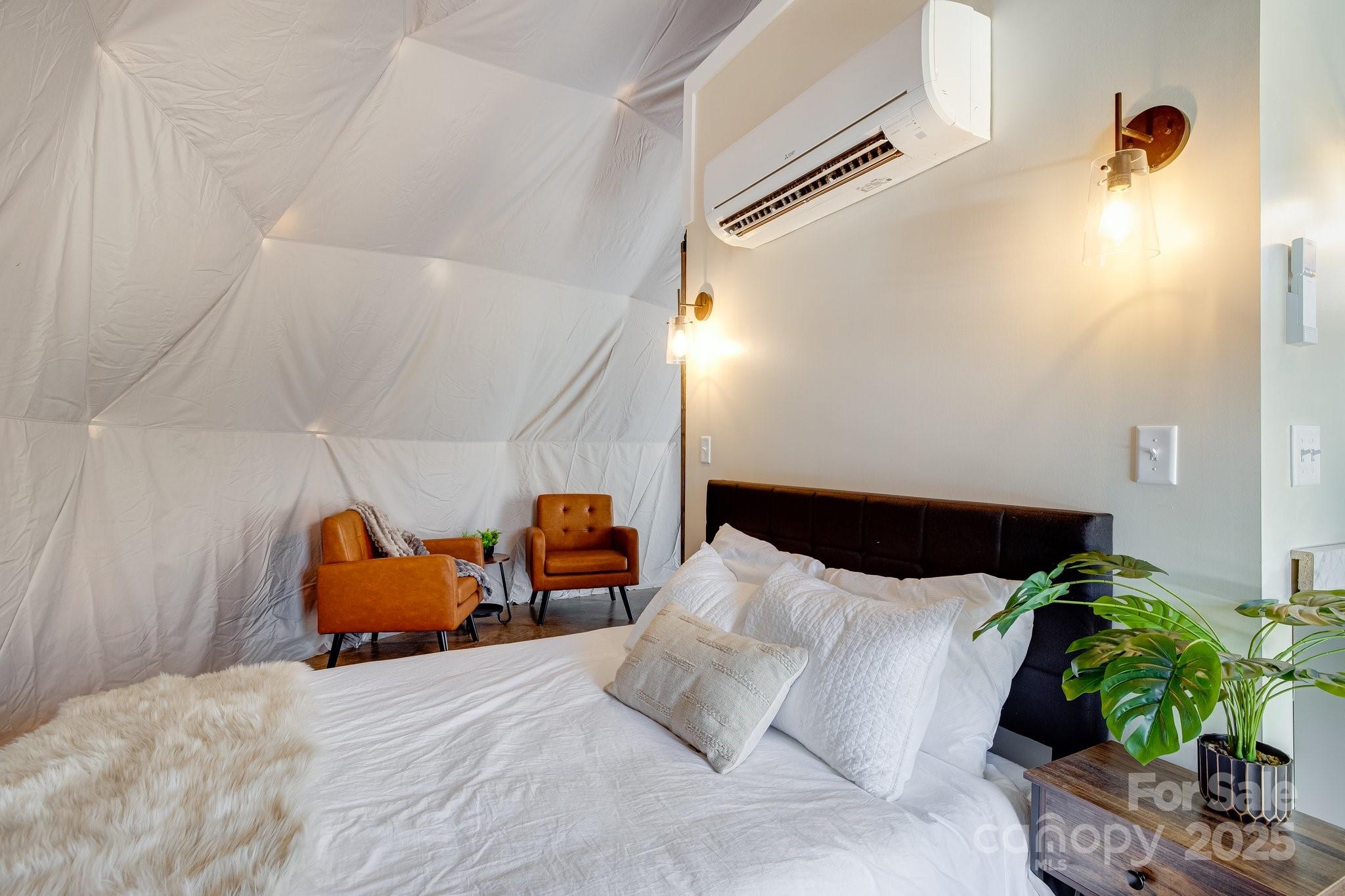 186 L Meece Road Rosman, NC 28772 - Photo 36 of 45 a bedroom with a bed and a potted plant