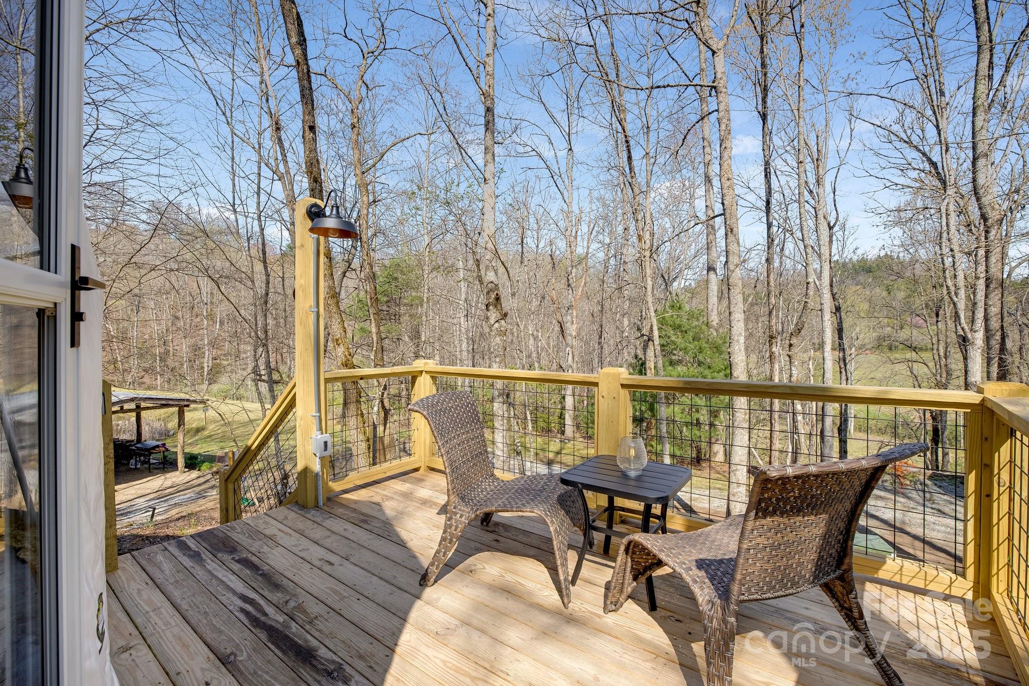 186 L Meece Road Rosman, NC 28772 - Photo 37 of 45 a view of a balcony with wooden chairs with wooden floor and outdoor space