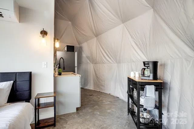 a kitchen with a sink a counter and a dining table
