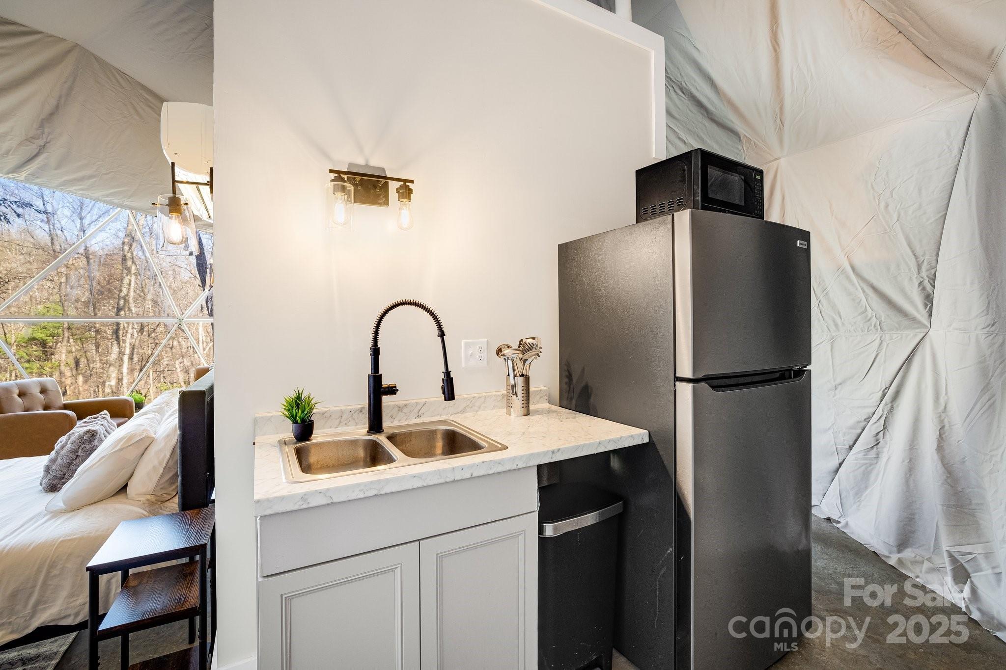 186 L Meece Road Rosman, NC 28772 - Photo 9 of 45 a kitchen with stainless steel appliances a refrigerator and a sink