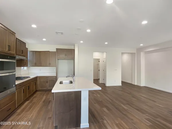 a kitchen with a sink appliances and cabinets