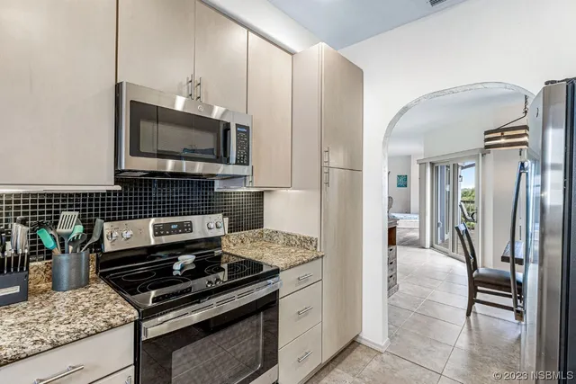 a bedroom with a large bed and a fireplace