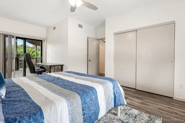 a bedroom with a large bed a couch and a window