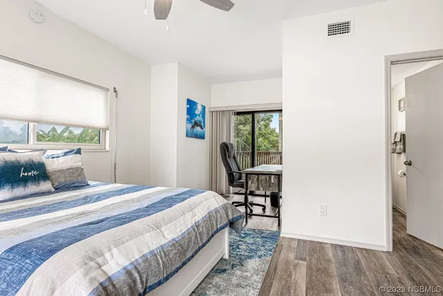 a bathroom with a granite countertop toilet sink and mirror