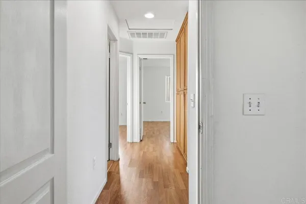 a view of a hallway with wooden floor