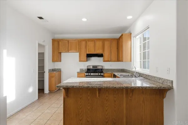 a kitchen with sink a window and a counter top space