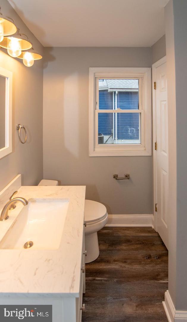913 Wise Avenue Baltimore, MD 21222 - Photo 8 of 11 a bathroom with a sink toilet and window