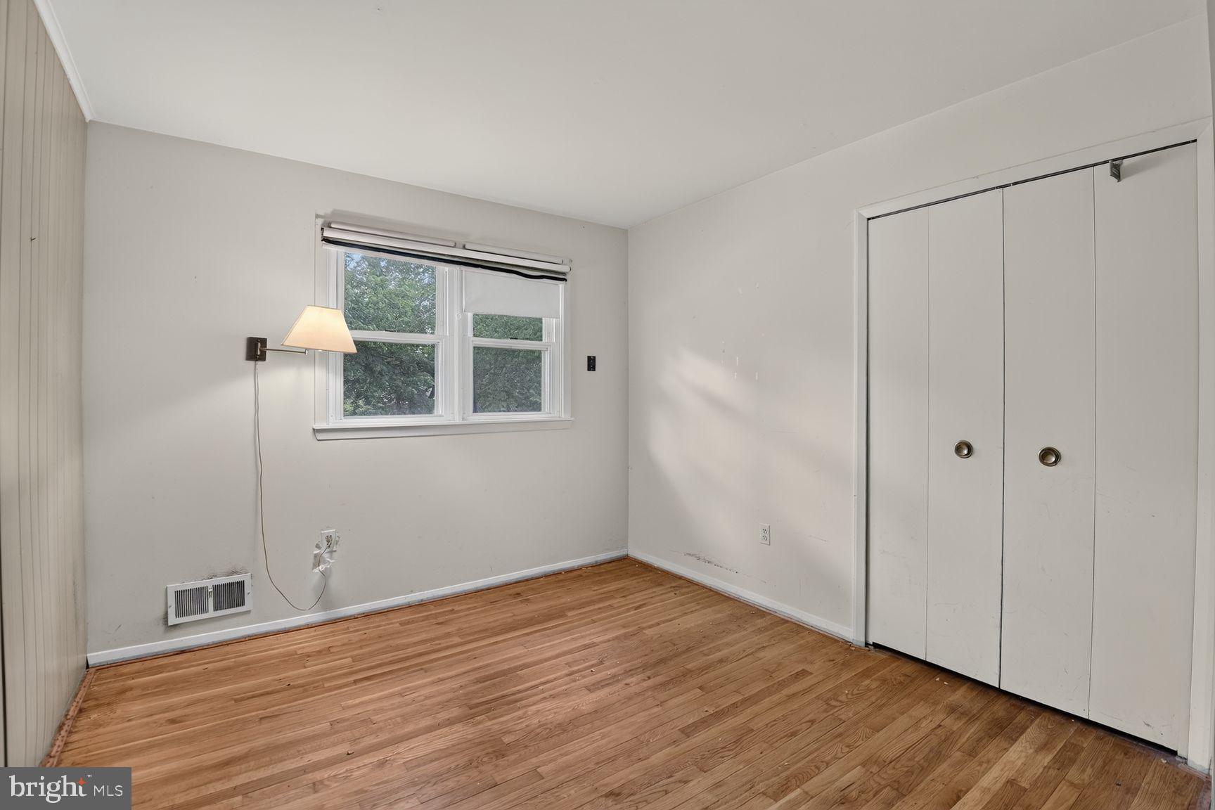 1326 Gresham Road Silver Spring, MD 20904 - Photo 23 of 30 a view of an empty room with wooden floor and a window