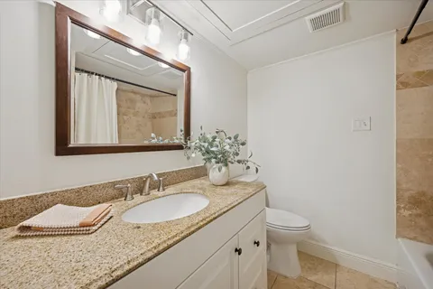 a kitchen with a sink and wooden floor