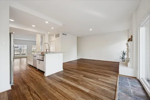 a view of kitchen with wooden floor and electronic appliances