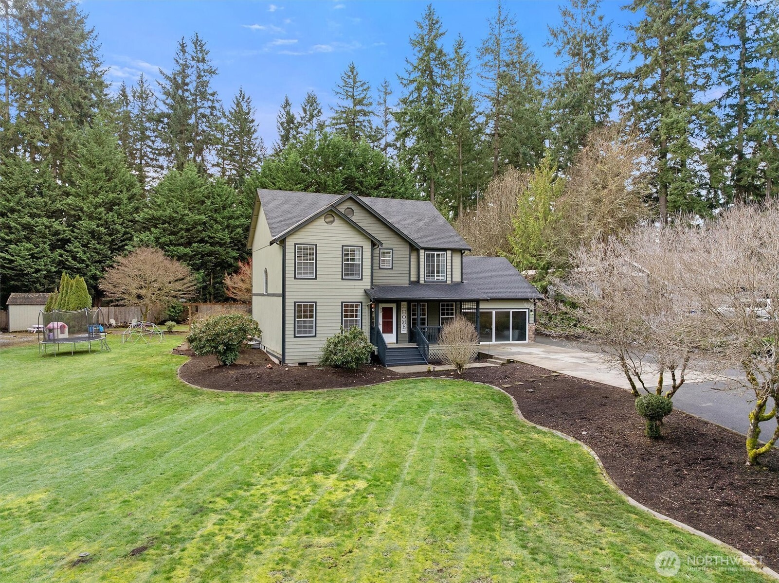 17018 45th Street East Lake Tapps, WA 98391 - Photo 1 of 40 a front view of a house with a garden and trees