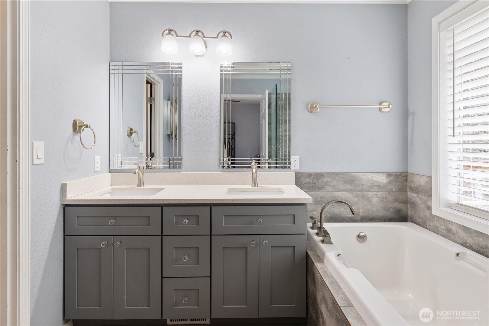 17018 45th Street East Lake Tapps, WA 98391 - Photo 20 of 40 a bathroom with a double vanity sink mirror and bathtub