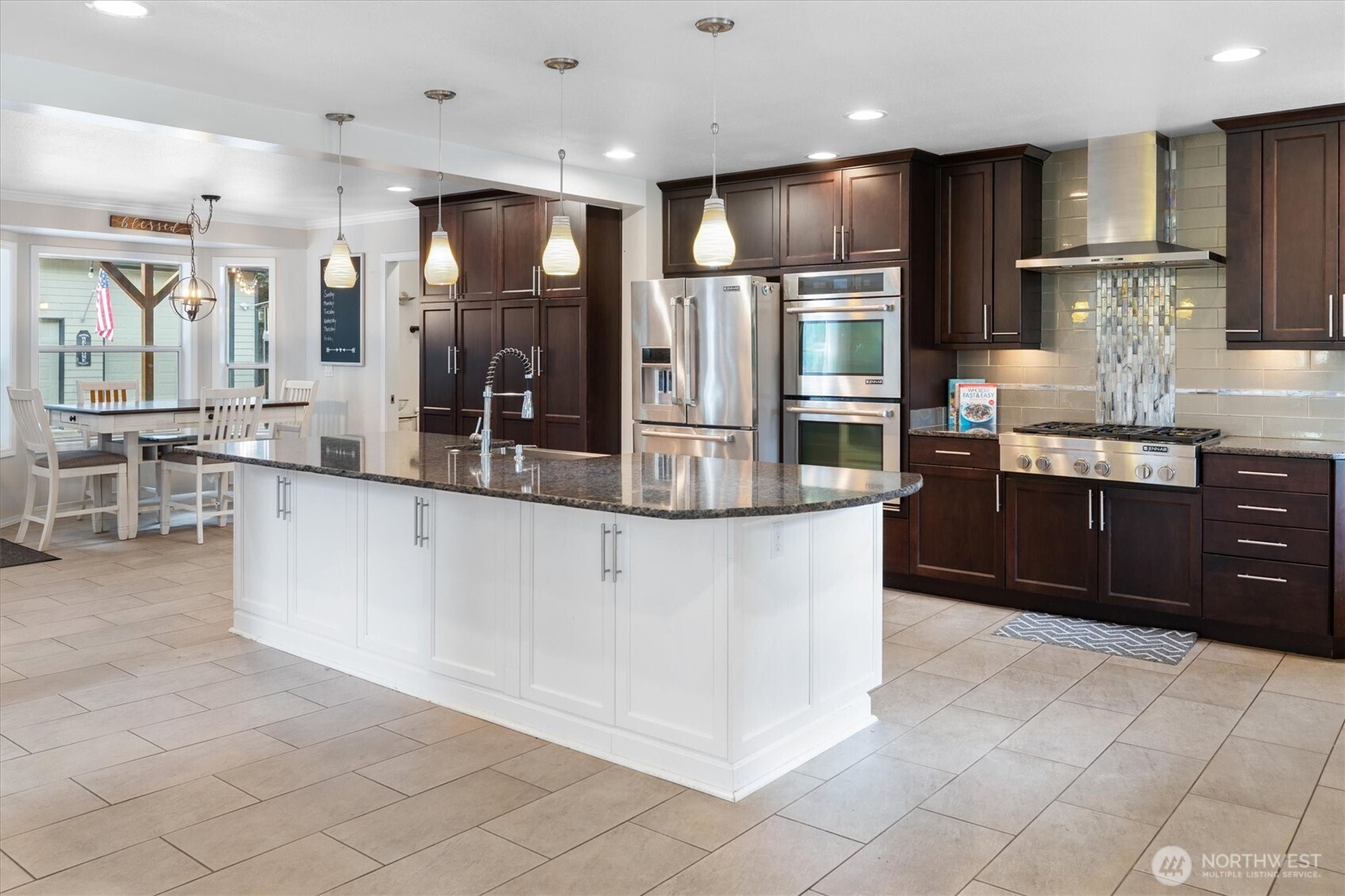 17018 45th Street East Lake Tapps, WA 98391 - Photo 5 of 40 a large kitchen with stainless steel appliances kitchen island granite countertop a large counter top and cabinets