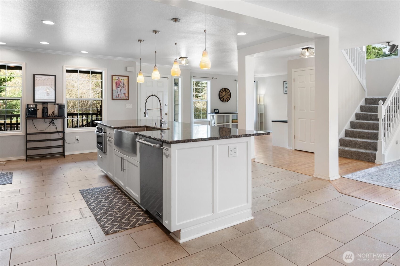 17018 45th Street East Lake Tapps, WA 98391 - Photo 8 of 40 a kitchen with stainless steel appliances kitchen island granite countertop a refrigerator and a stove top oven