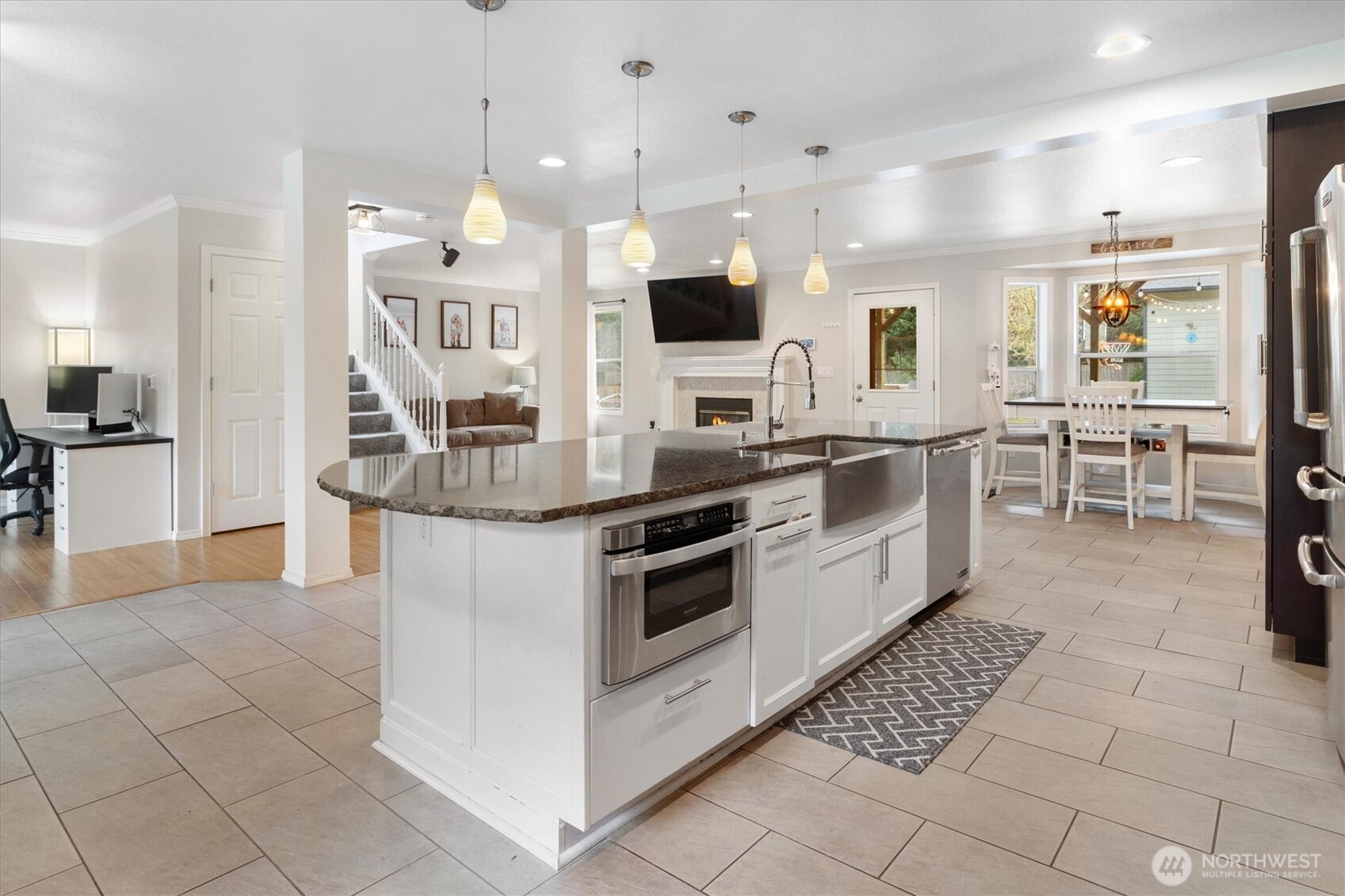 17018 45th Street East Lake Tapps, WA 98391 - Photo 10 of 40 a kitchen with stainless steel appliances kitchen island granite countertop a sink and cabinets