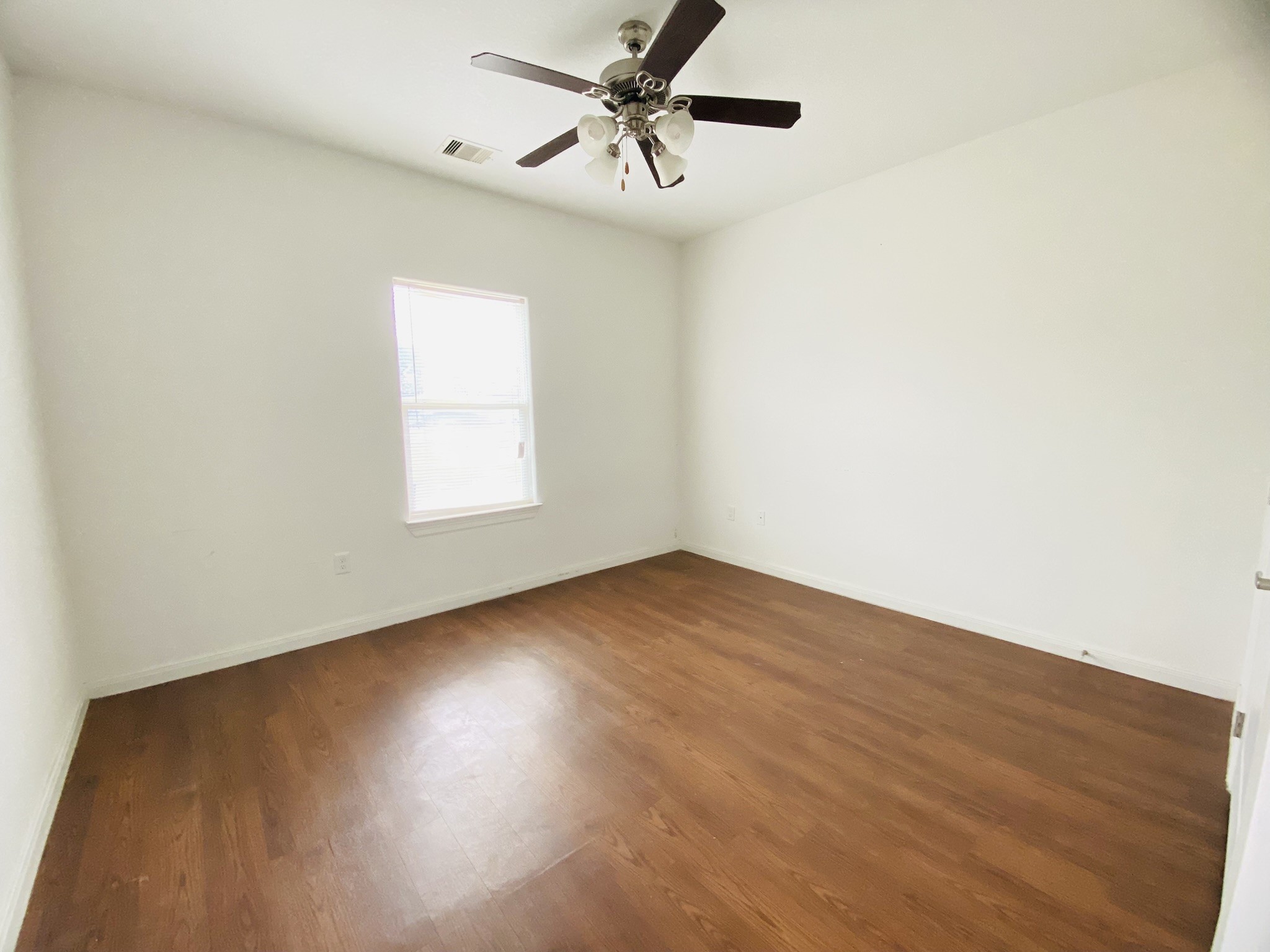 2503 Deats Road Dickinson, TX 77539 - Photo 15 of 28 an empty room with a window and a ceiling fan