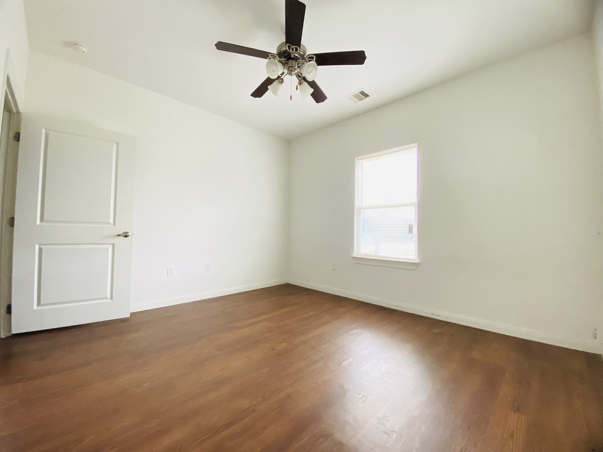 2503 Deats Road Dickinson, TX 77539 - Photo 16 of 28 an empty room with windows and fan