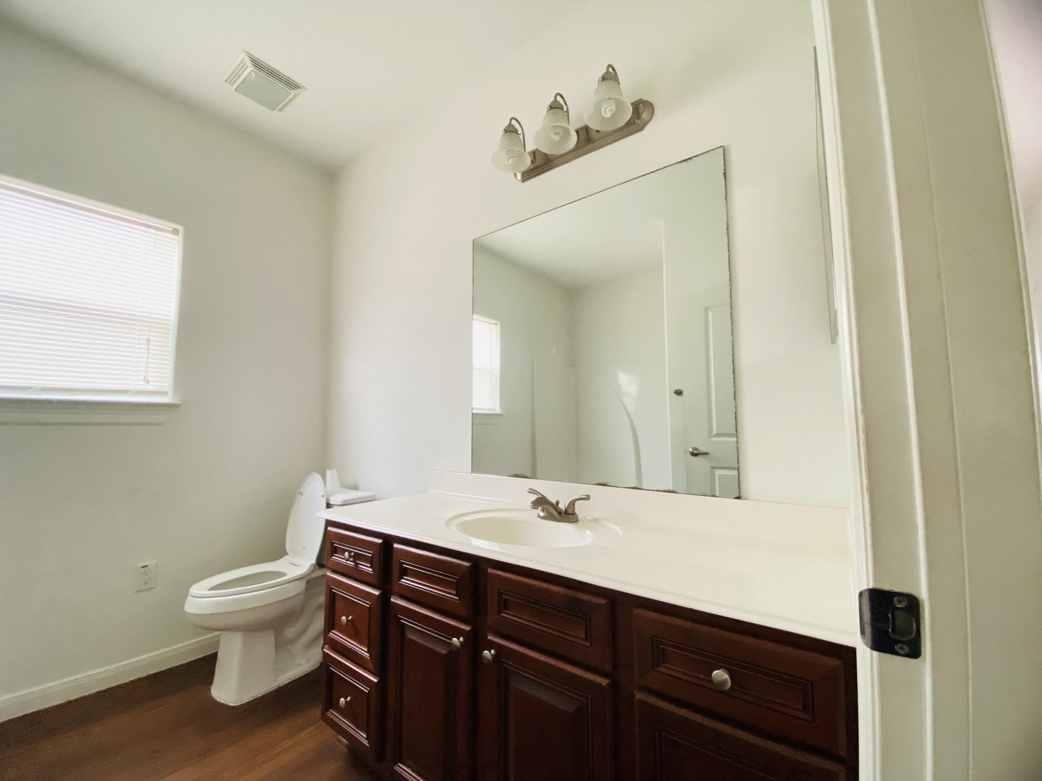 2503 Deats Road Dickinson, TX 77539 - Photo 17 of 28 a bathroom with a toilet a sink and mirror