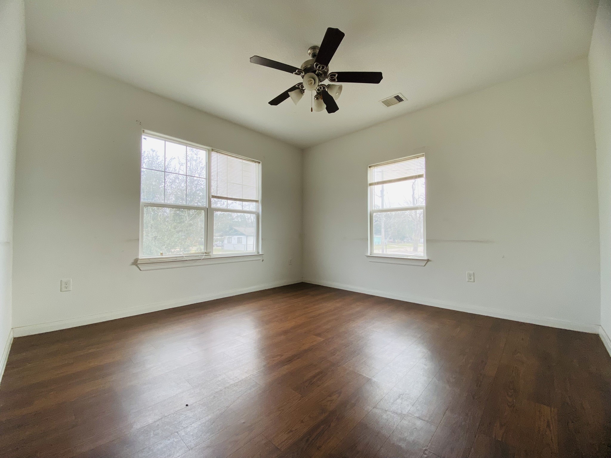2503 Deats Road Dickinson, TX 77539 - Photo 6 of 28 a view of an empty room with wooden floor and a window