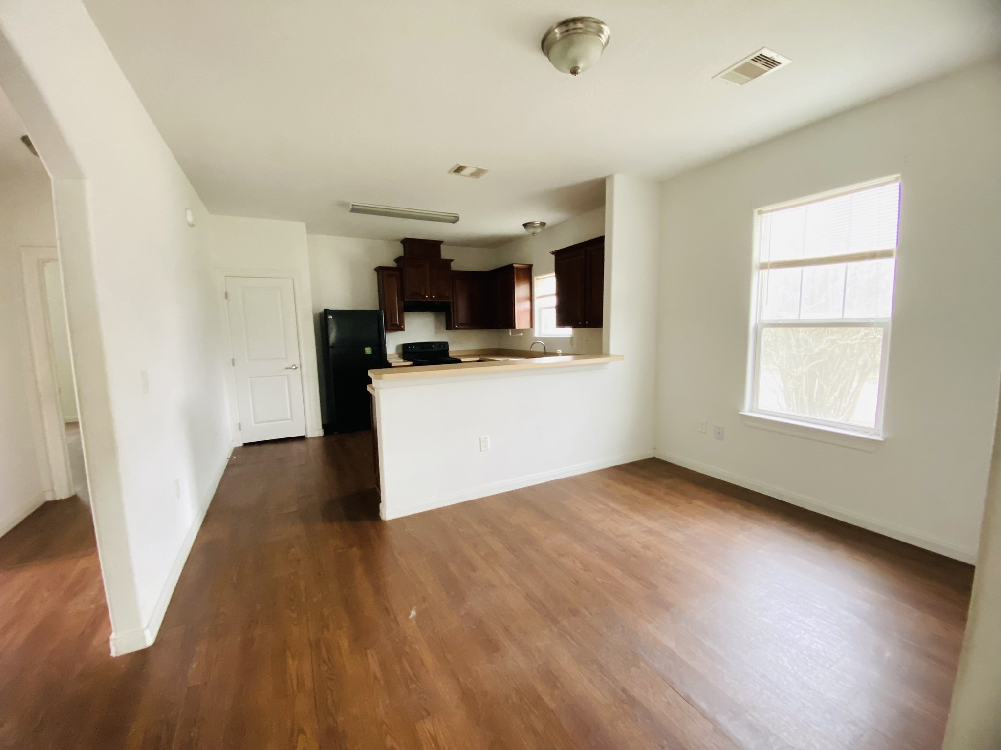 2503 Deats Road Dickinson, TX 77539 - Photo 8 of 28 a view of a kitchen with a sink dishwasher oven window and wooden floor