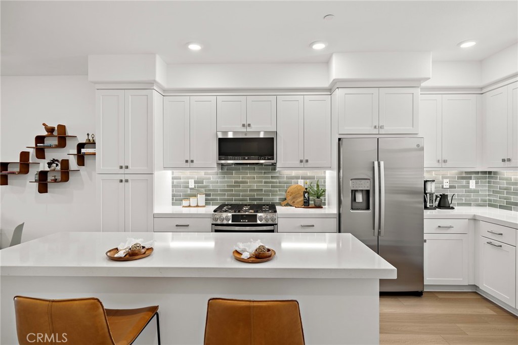 61 Wheelbarrow Road Rancho Mission Viejo, CA 92694 - Photo 1 of 74 a kitchen with stainless steel appliances a stove a sink and a refrigerator