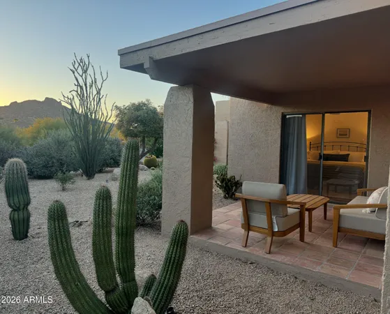 a view of a big house with a yard and plants