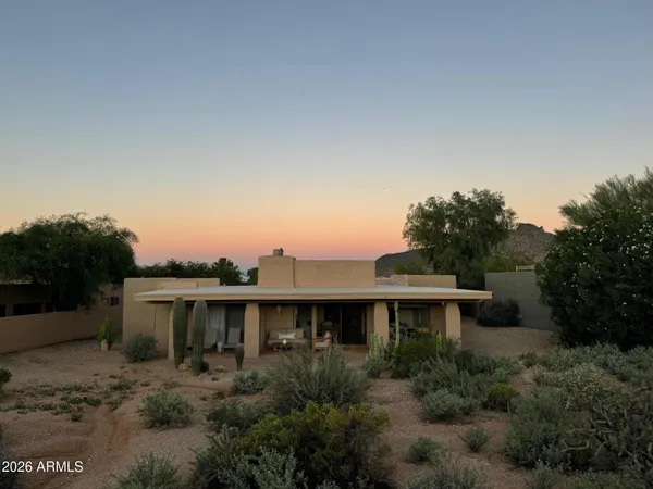 an aerial view of a house with garden space and street view