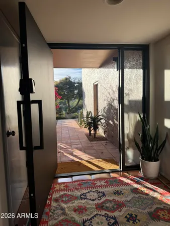 a view of a living room with a floor to ceiling window and floor to ceiling window