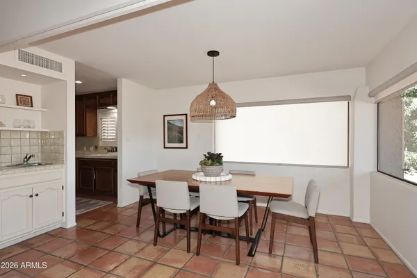 a dining room with furniture and window