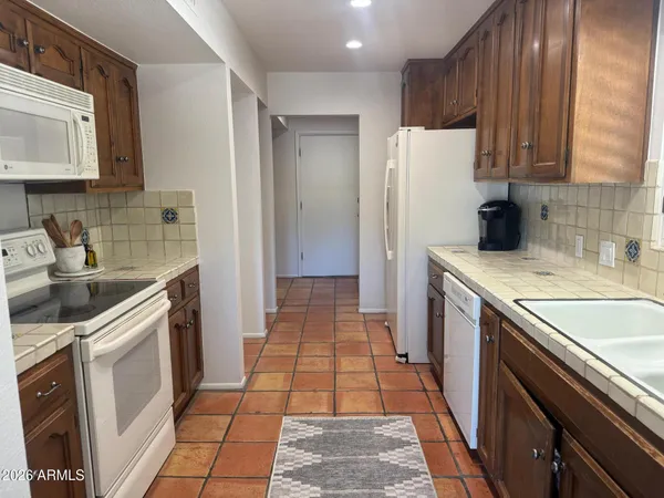 a kitchen with a sink stove and refrigerator