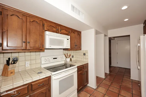 a kitchen with a sink cabinets and appliances