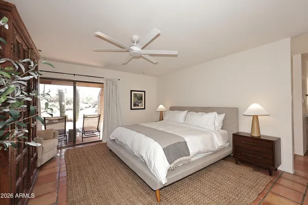 a bedroom with a large bed and a chandelier