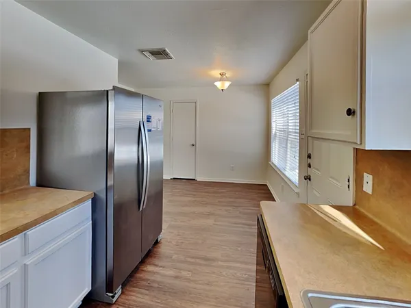 a kitchen with stainless steel appliances a refrigerator and a stove