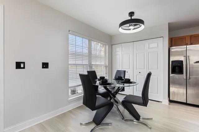 a view of a dining room with furniture and window