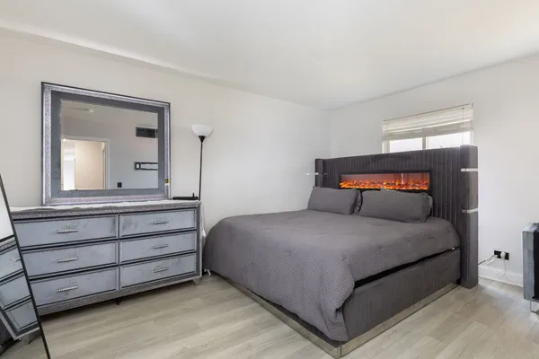 a bedroom with a large bed and a dresser