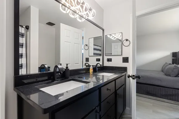 a kitchen with a sink refrigerator and cabinets
