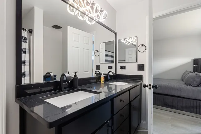 a kitchen with a sink refrigerator and cabinets