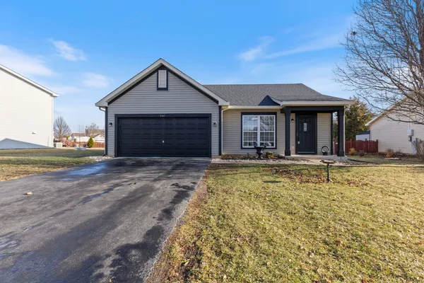 a view of a house with a yard and garage