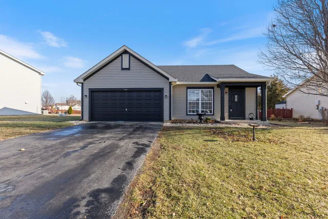 a view of a house with a yard and garage