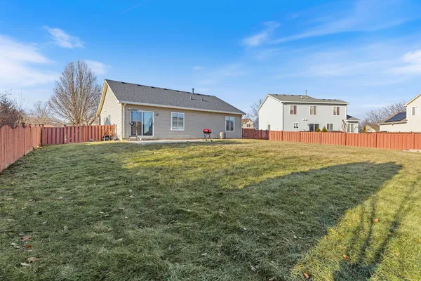 a large house with a big yard and large trees