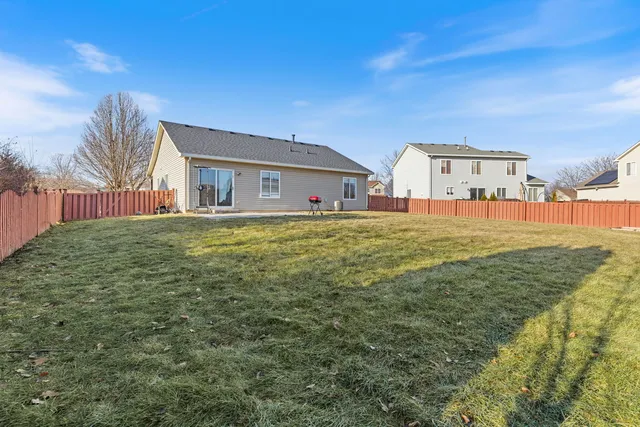 a large house with a big yard and large trees