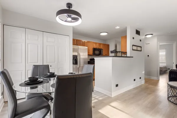 a kitchen with stainless steel appliances kitchen island granite countertop a refrigerator and a stove top oven