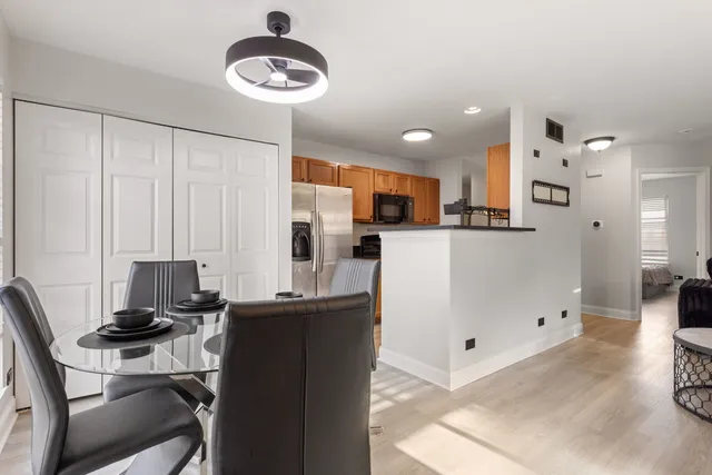 a kitchen with stainless steel appliances kitchen island granite countertop a refrigerator and a stove top oven